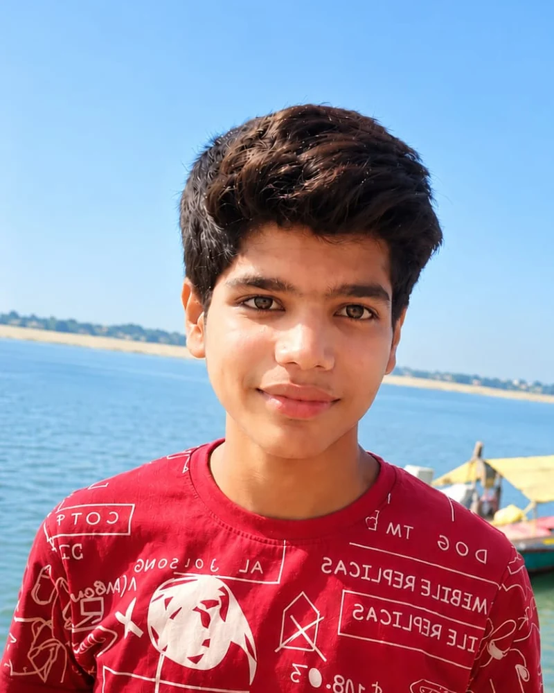 Prabhat Tiwari in a red shirt beside the water